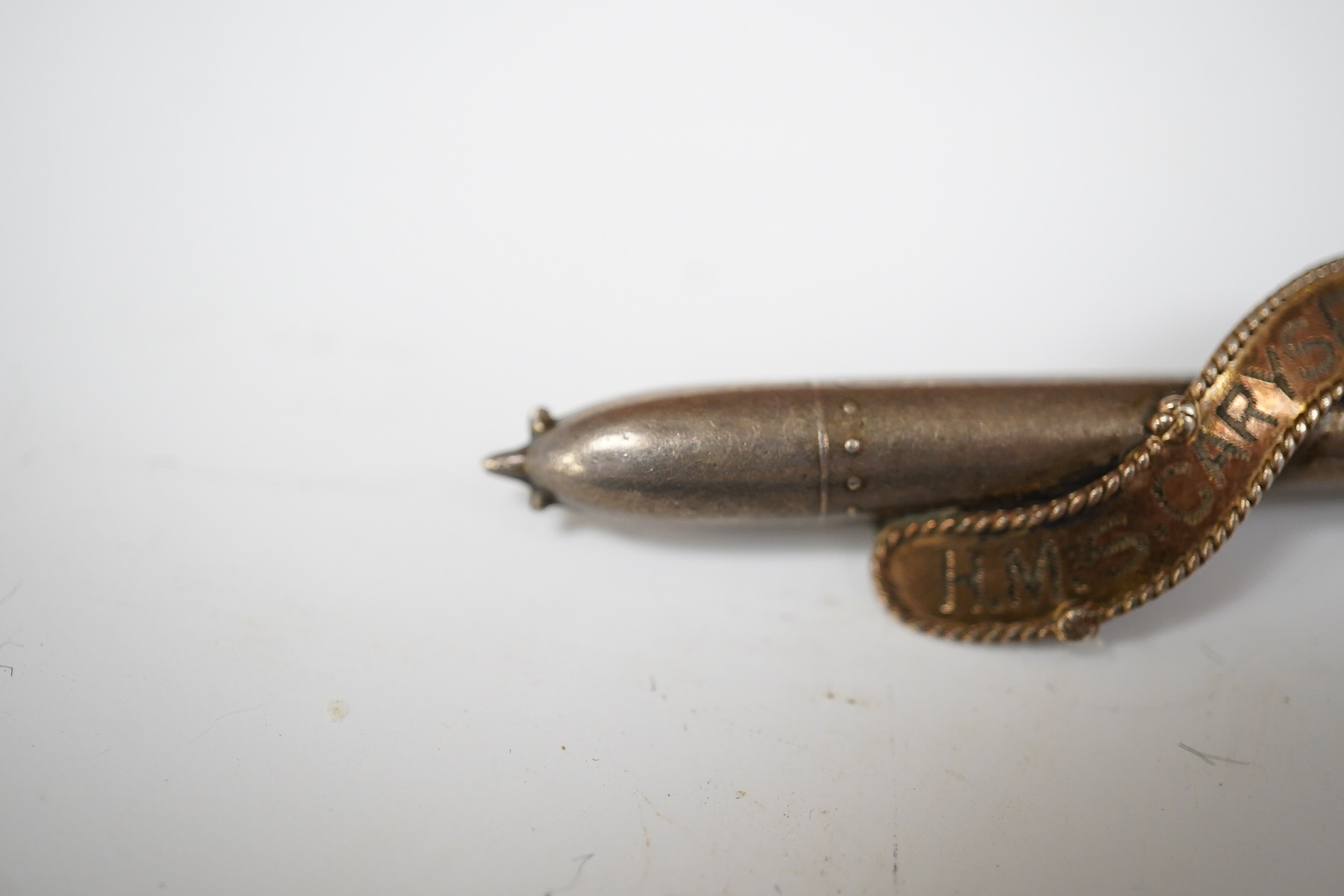 A WW1 silver sweethearts brooch from HMS Caryfort modelled as a torpedo